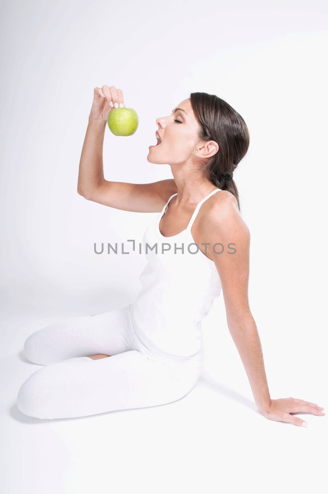 Woman eating a green apple
