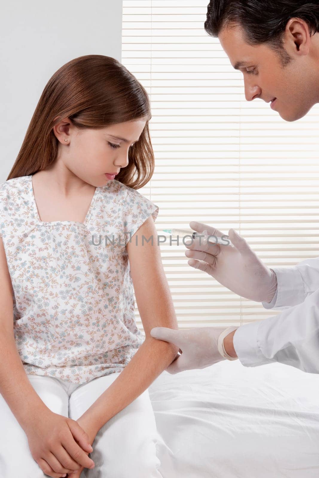 Doctor giving an injecting to a girl