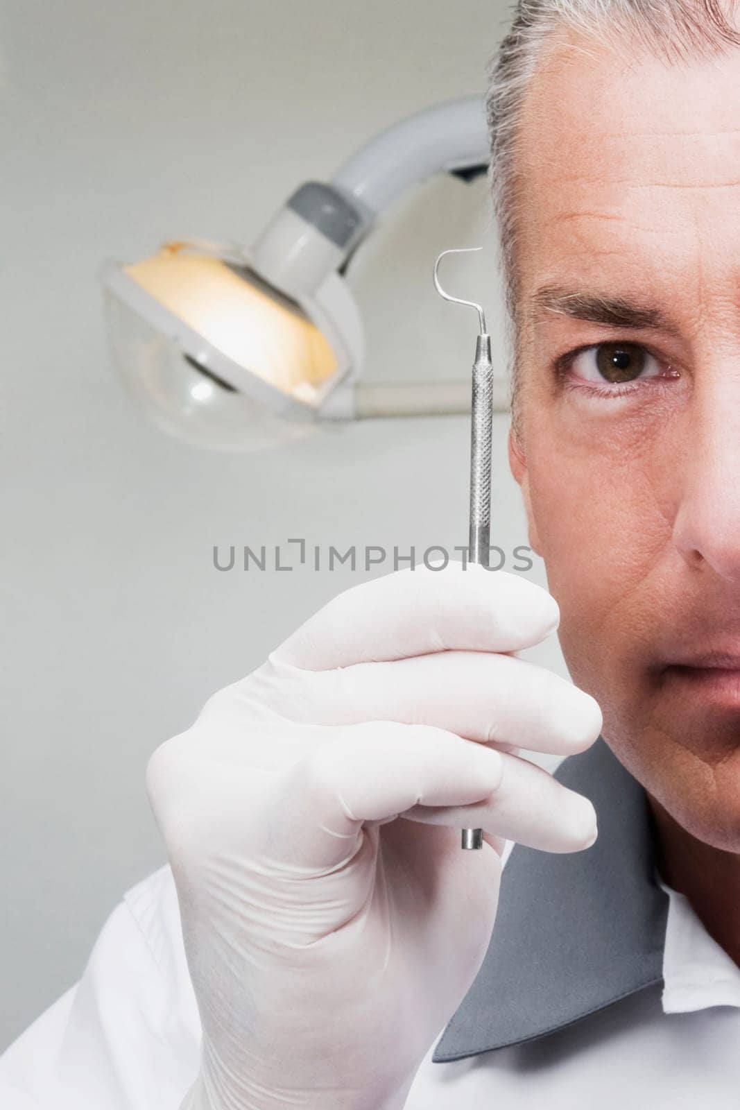 Dentist holding a dental scaler