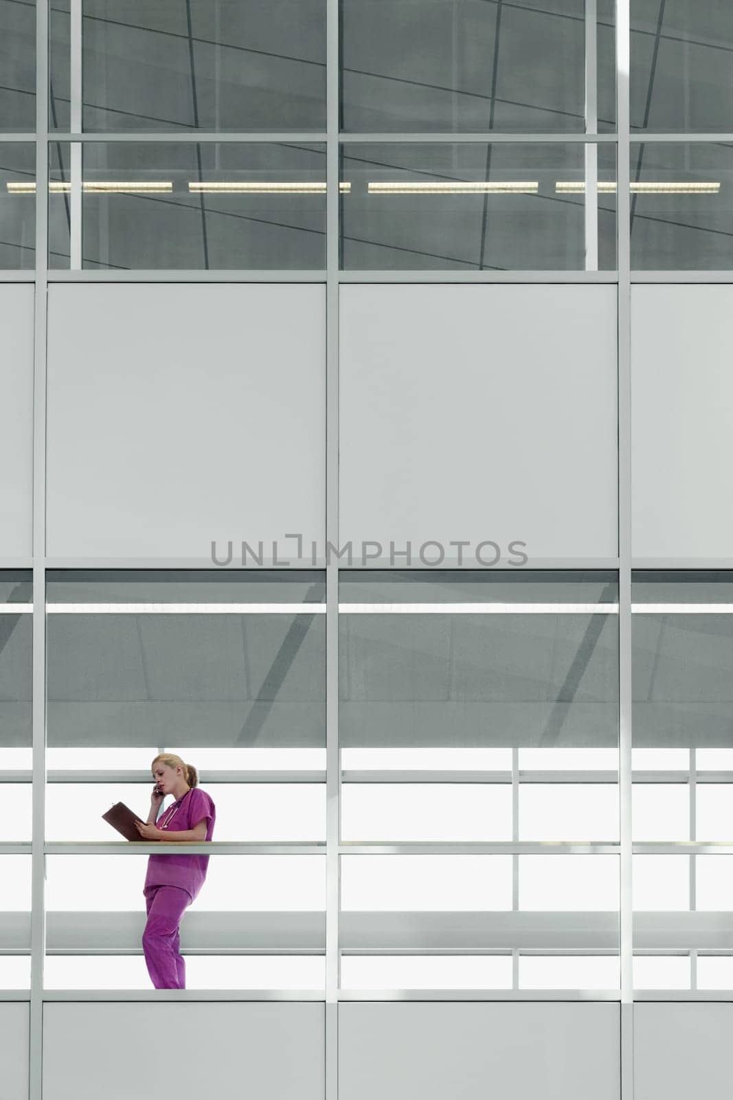 Female doctor talking on a mobile phone in a hospital