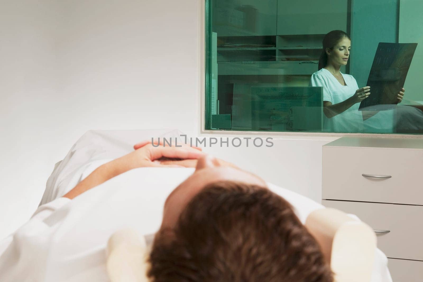 Nurse examining MRI scan of a patient