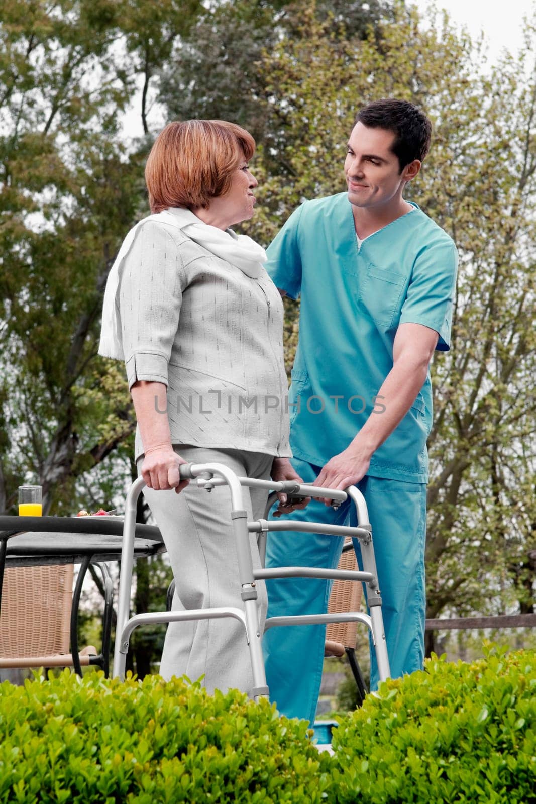 Health worker assisting a disabled woman in a rehabilitation center