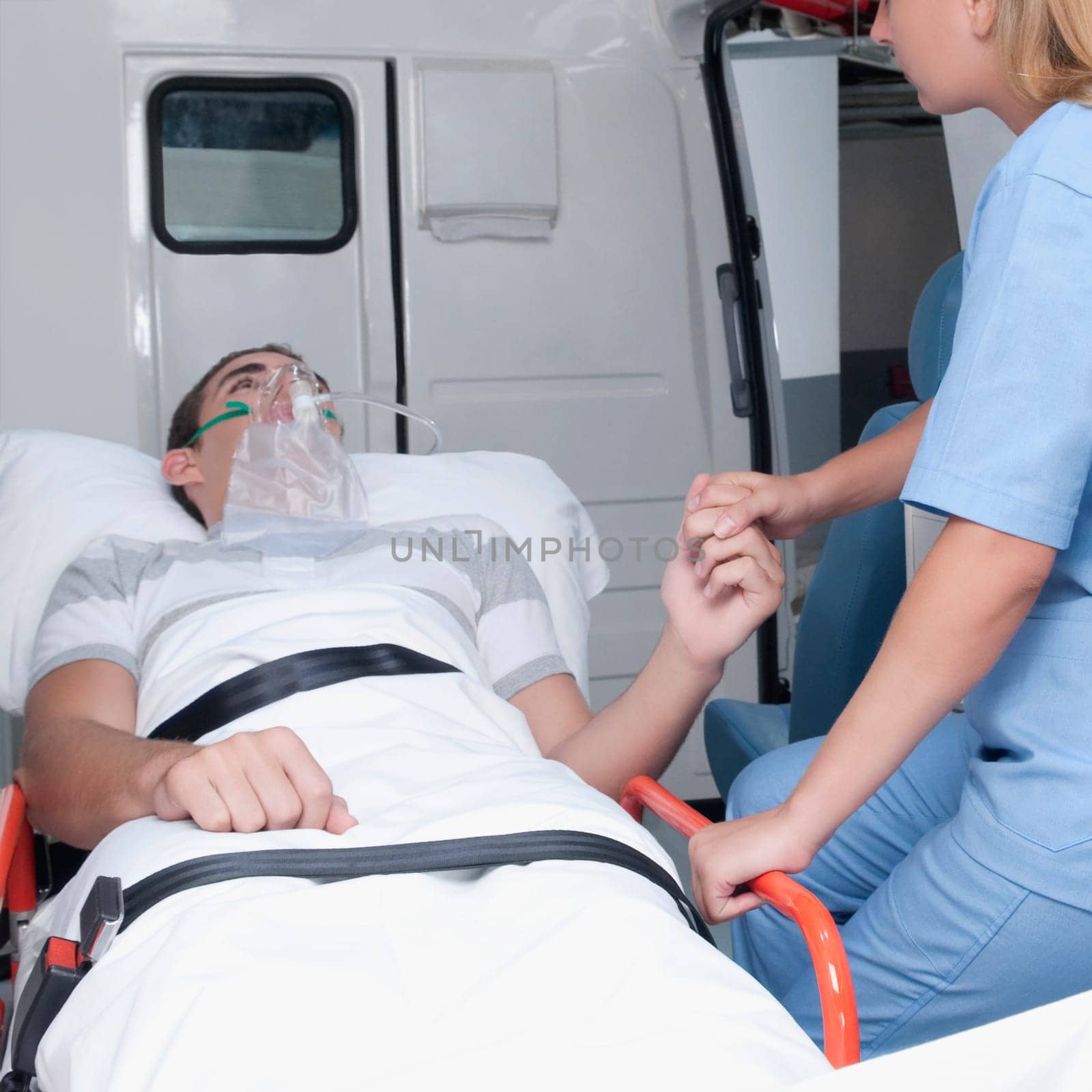 Female nurse assisting a patient in an ambulance