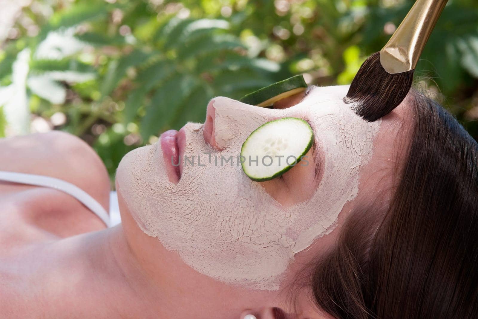 Woman applying a facial mask
