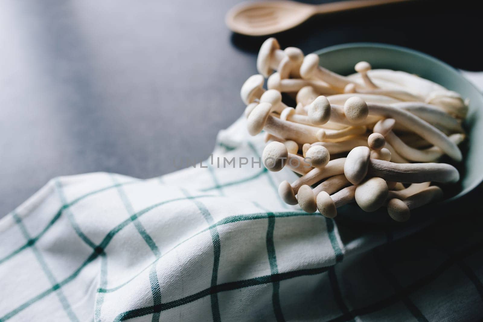 Cooking white mushrooms on the dark gray background. High quality photo