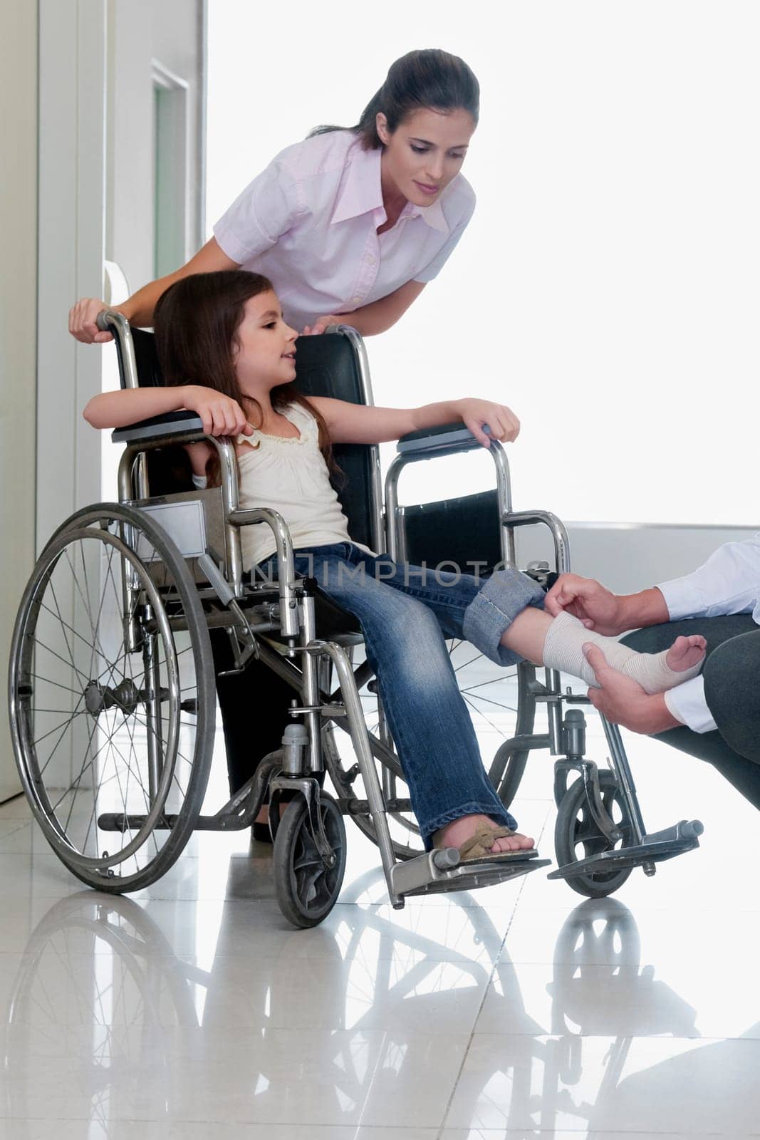 Female doctor with a patient in a wheelchair