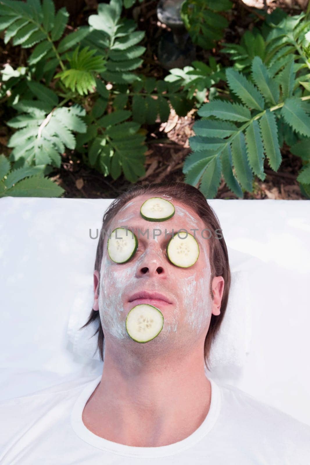 Cucumber slices on a manŽs face