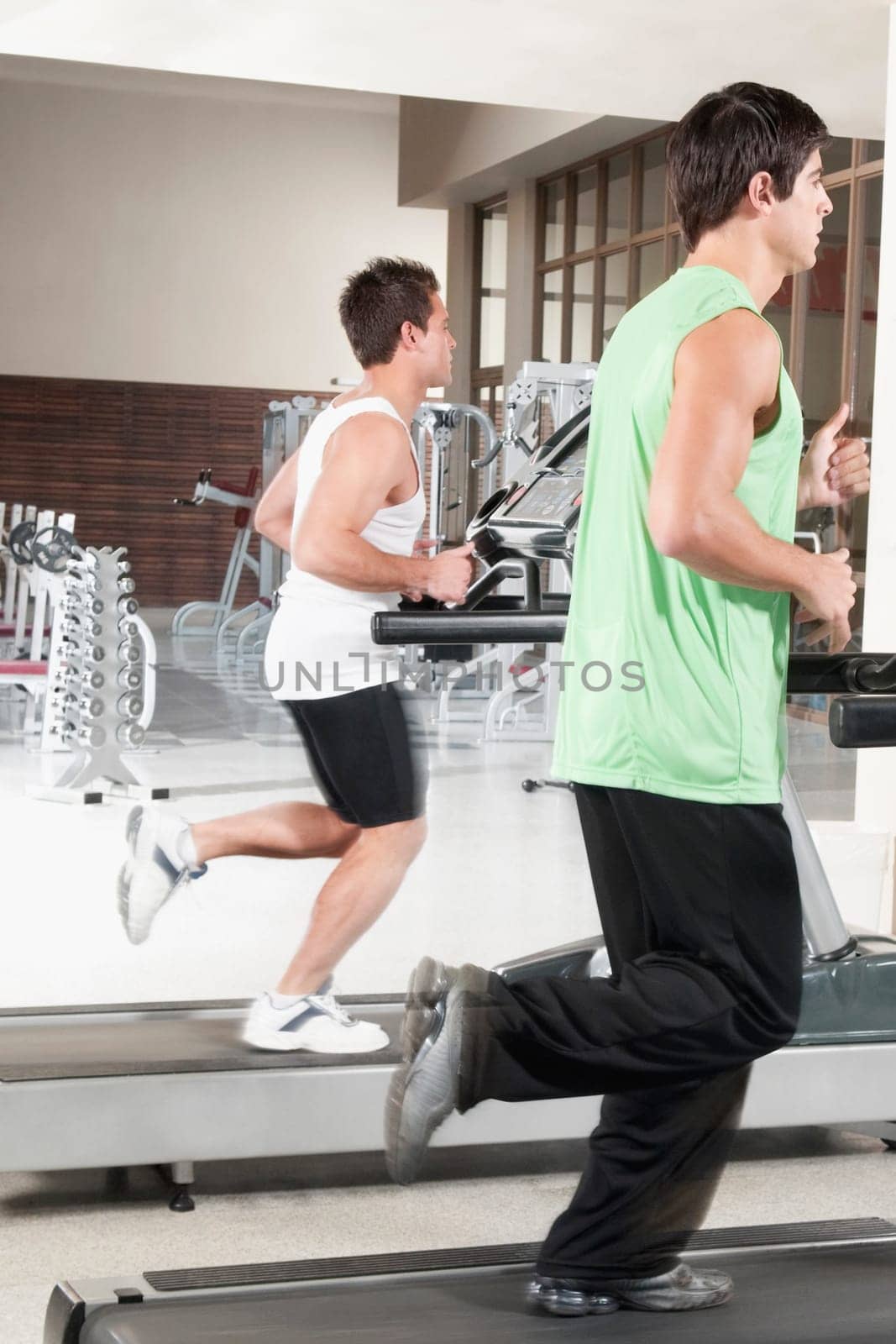 Two men running on treadmills
