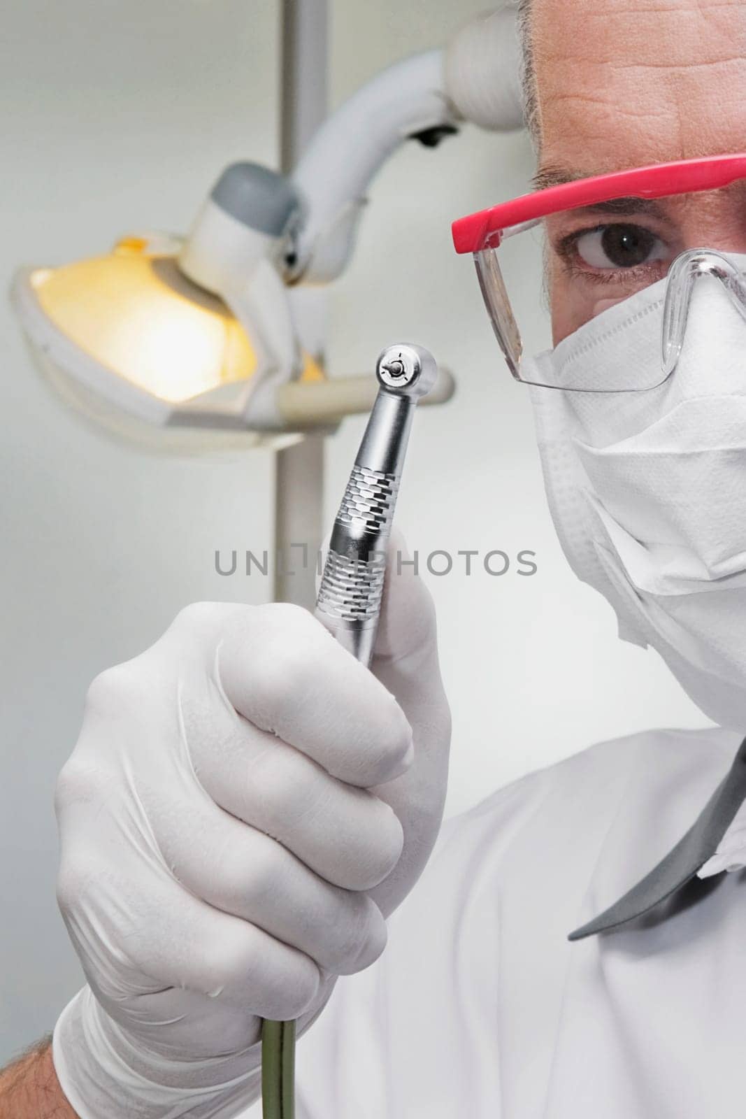 Dentist holding a dental drill