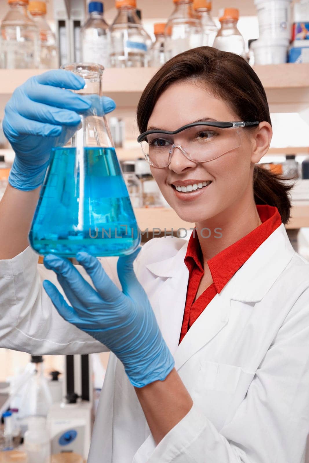 Female doctor holding a conical flask in a laboratory