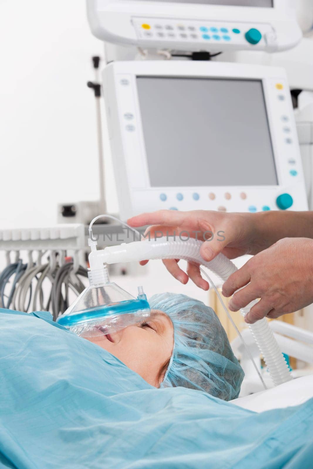 Anesthetist using an oxygen mask on a patient in a hospital