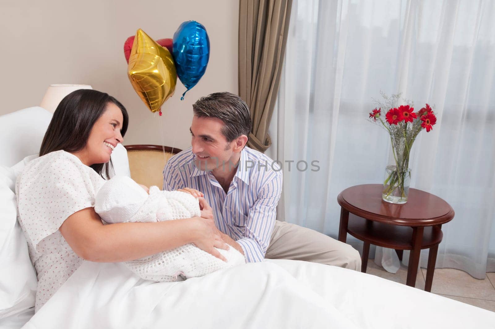 Couple with their newborn baby in a hospital