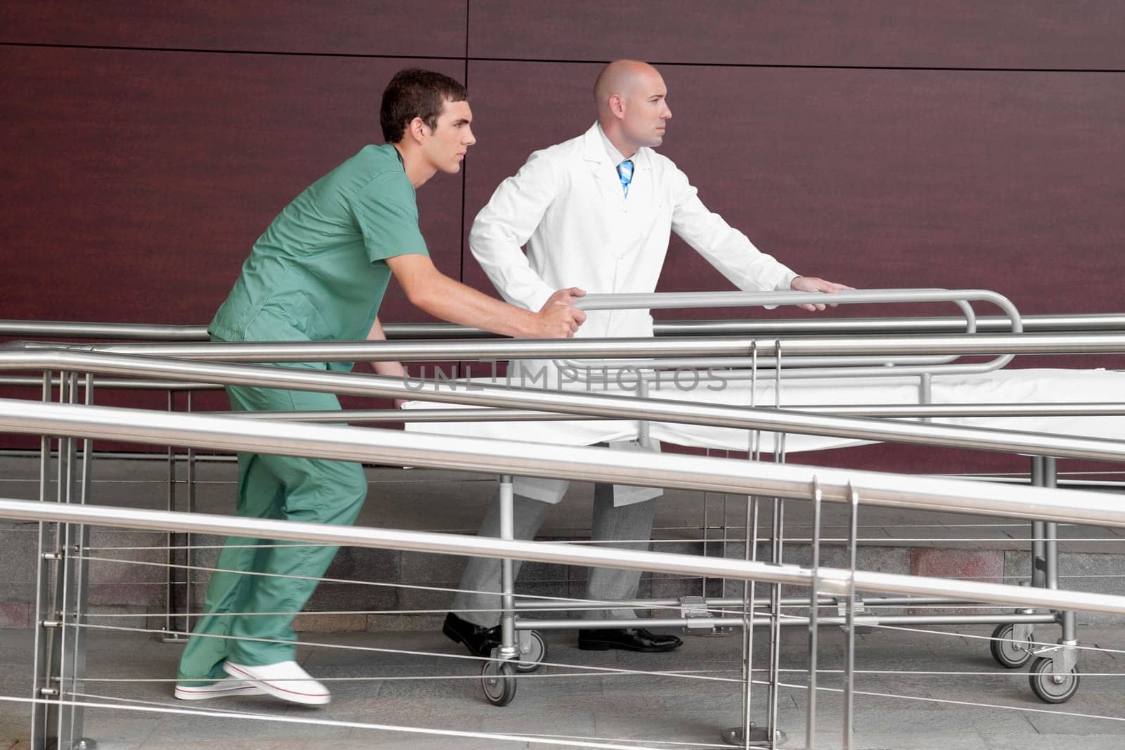 Doctor with a male nurse pushing a stretcher