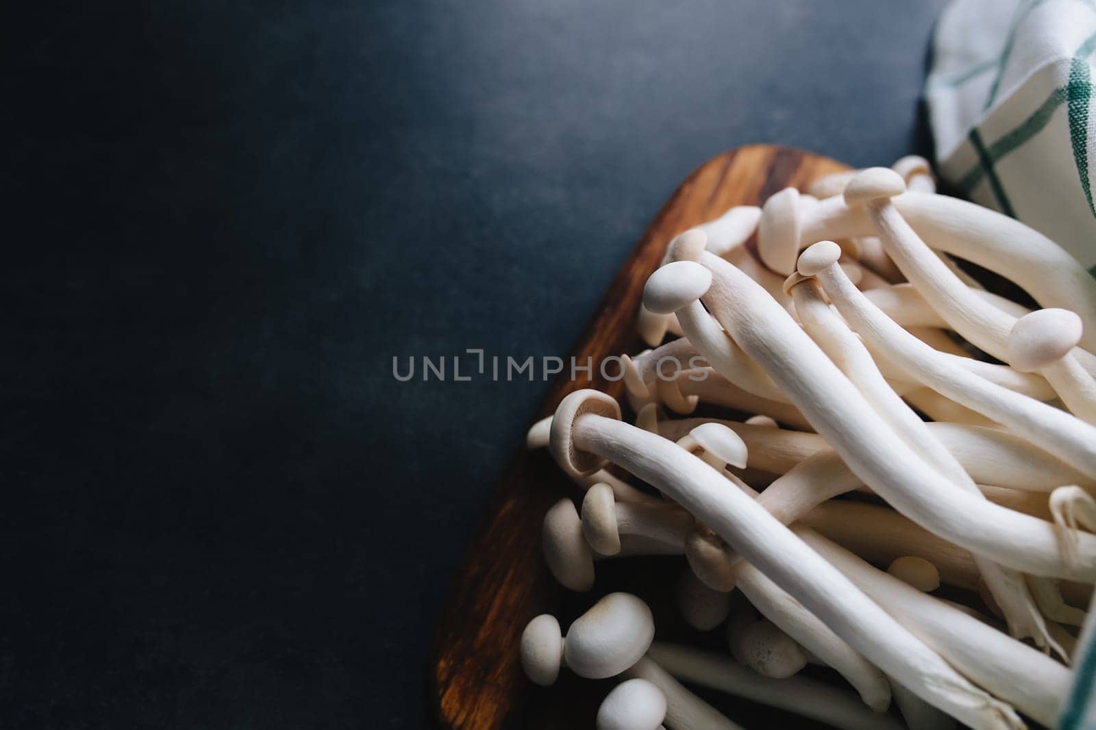 Cooking white mushrooms on the dark gray background. High quality photo