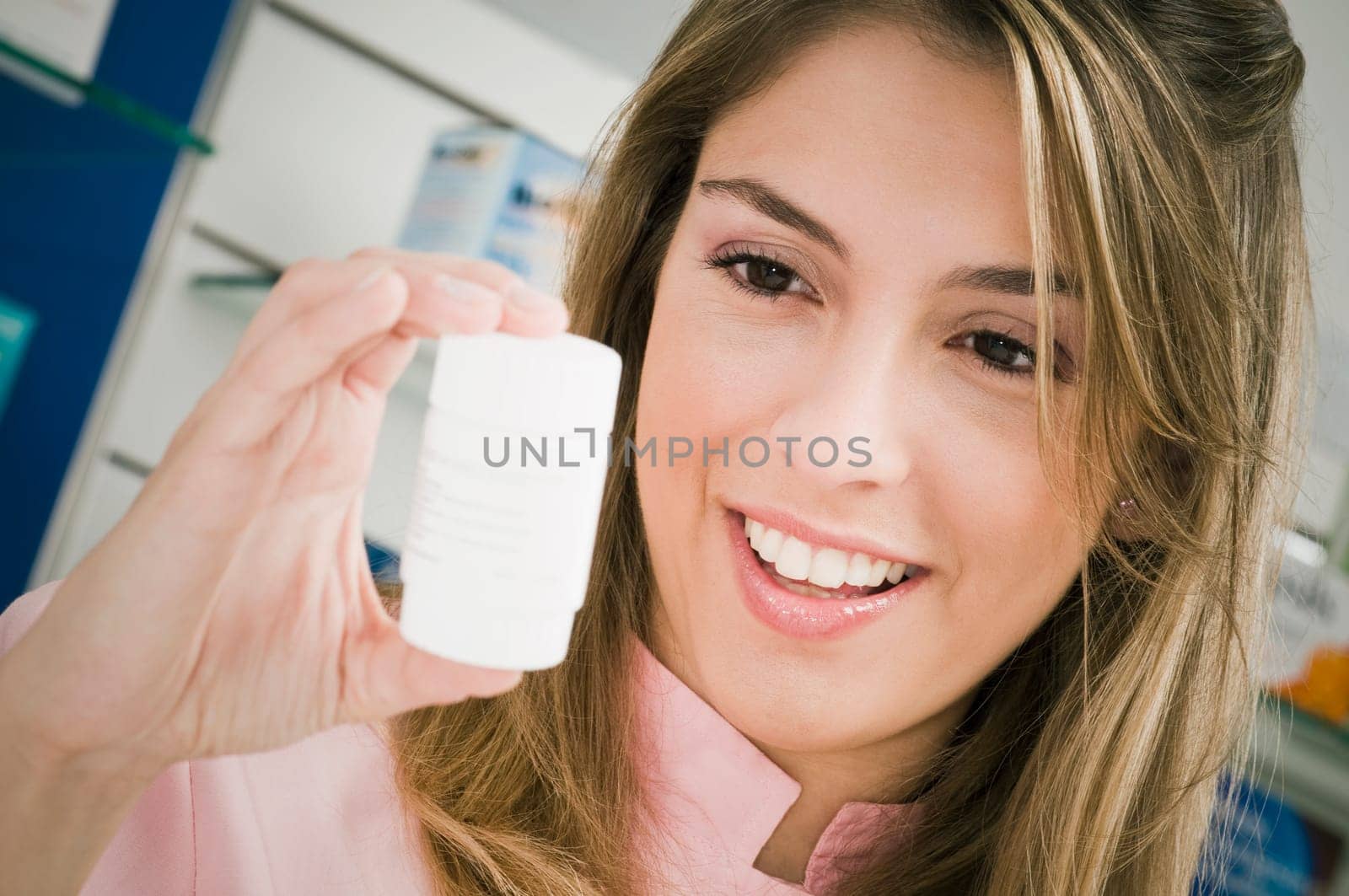 Female pharmacist holding a medicine bottle