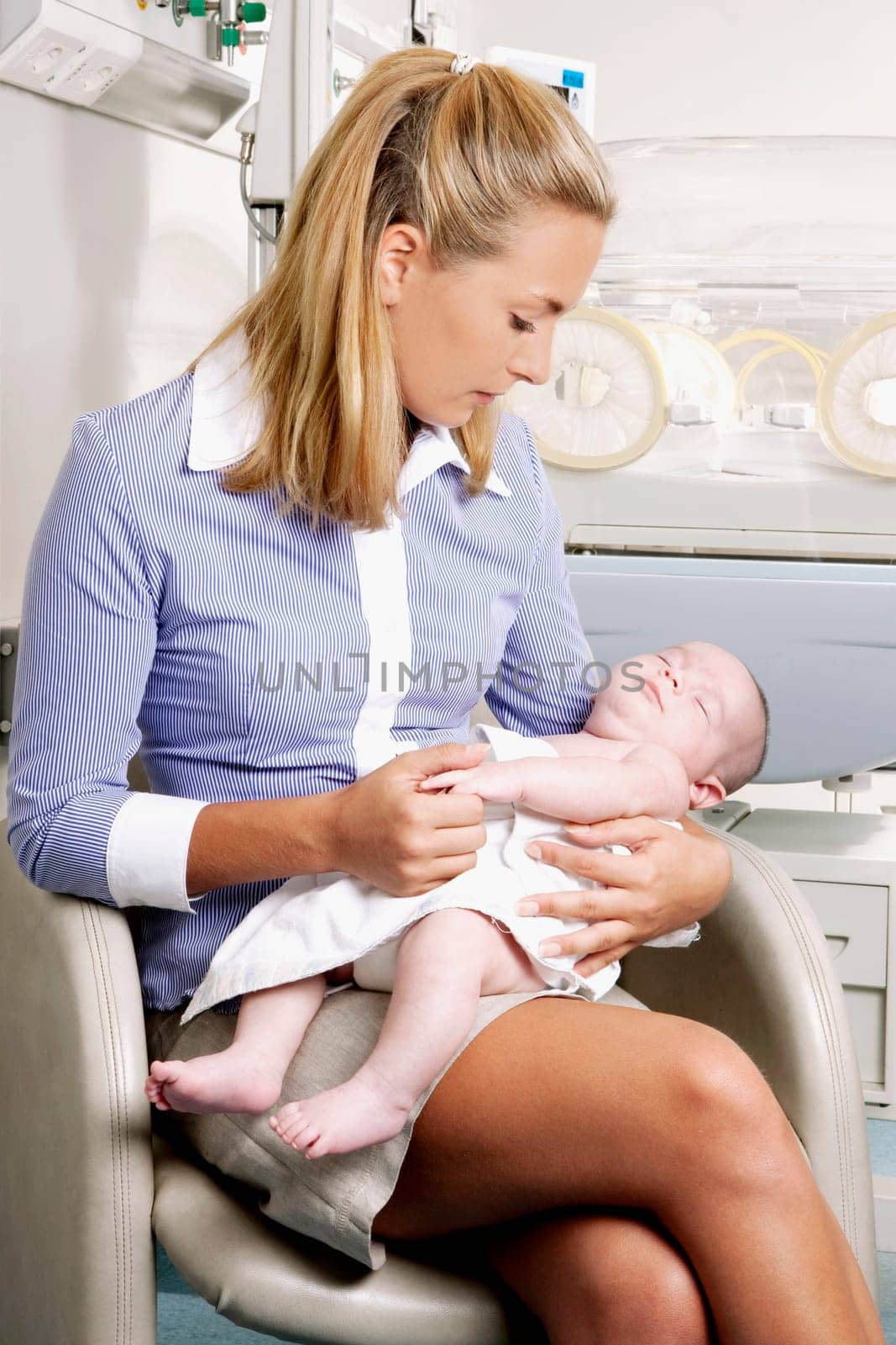 Woman carrying her newborn baby
