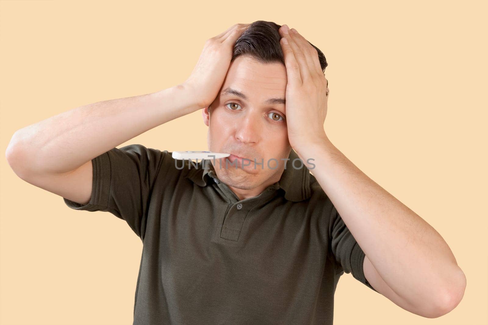 Man checking his temperature with a thermometer
