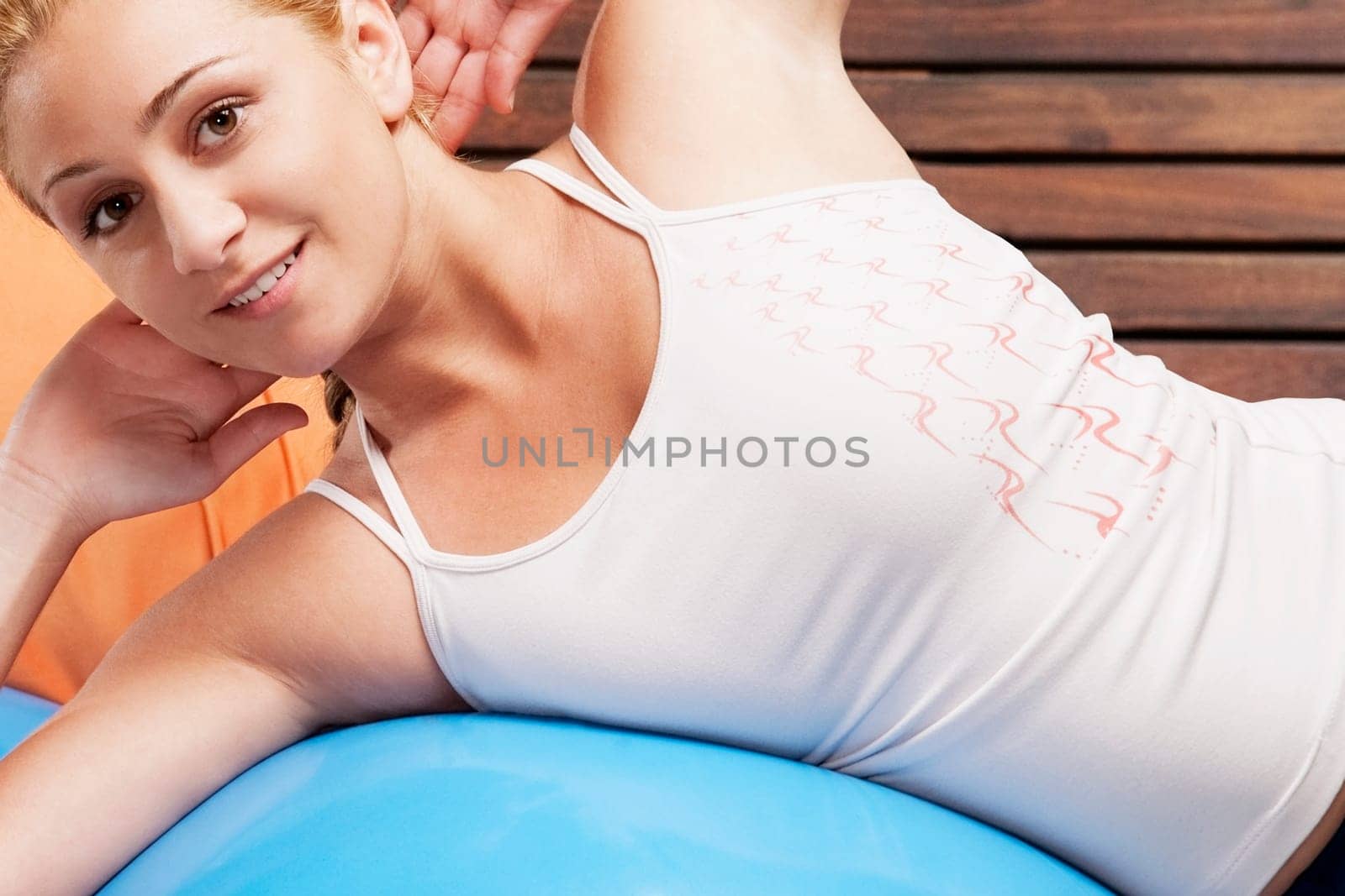 Woman exercising on a fitness ball in a gym