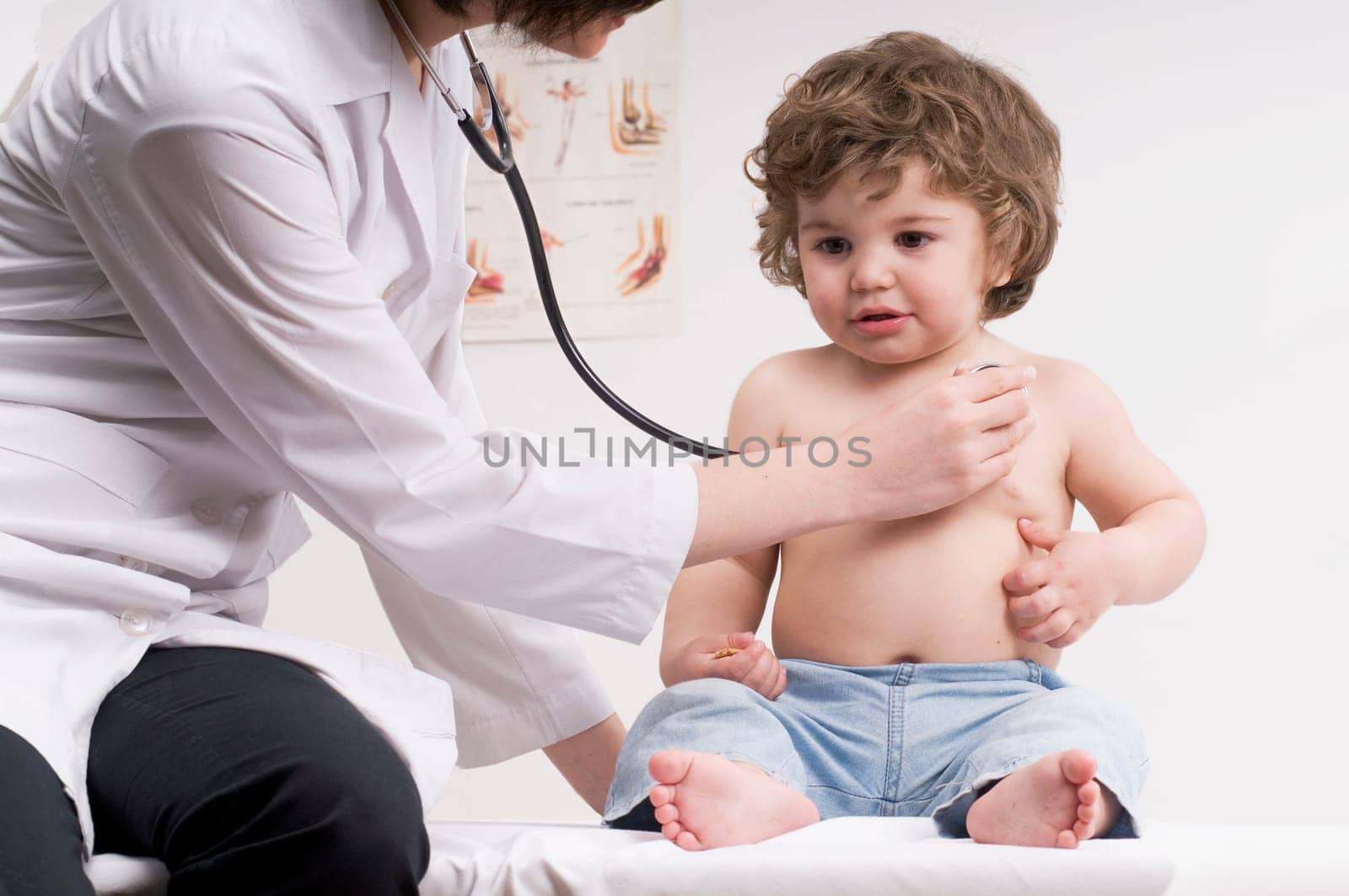Female doctor examining a baby boy with a stethoscope