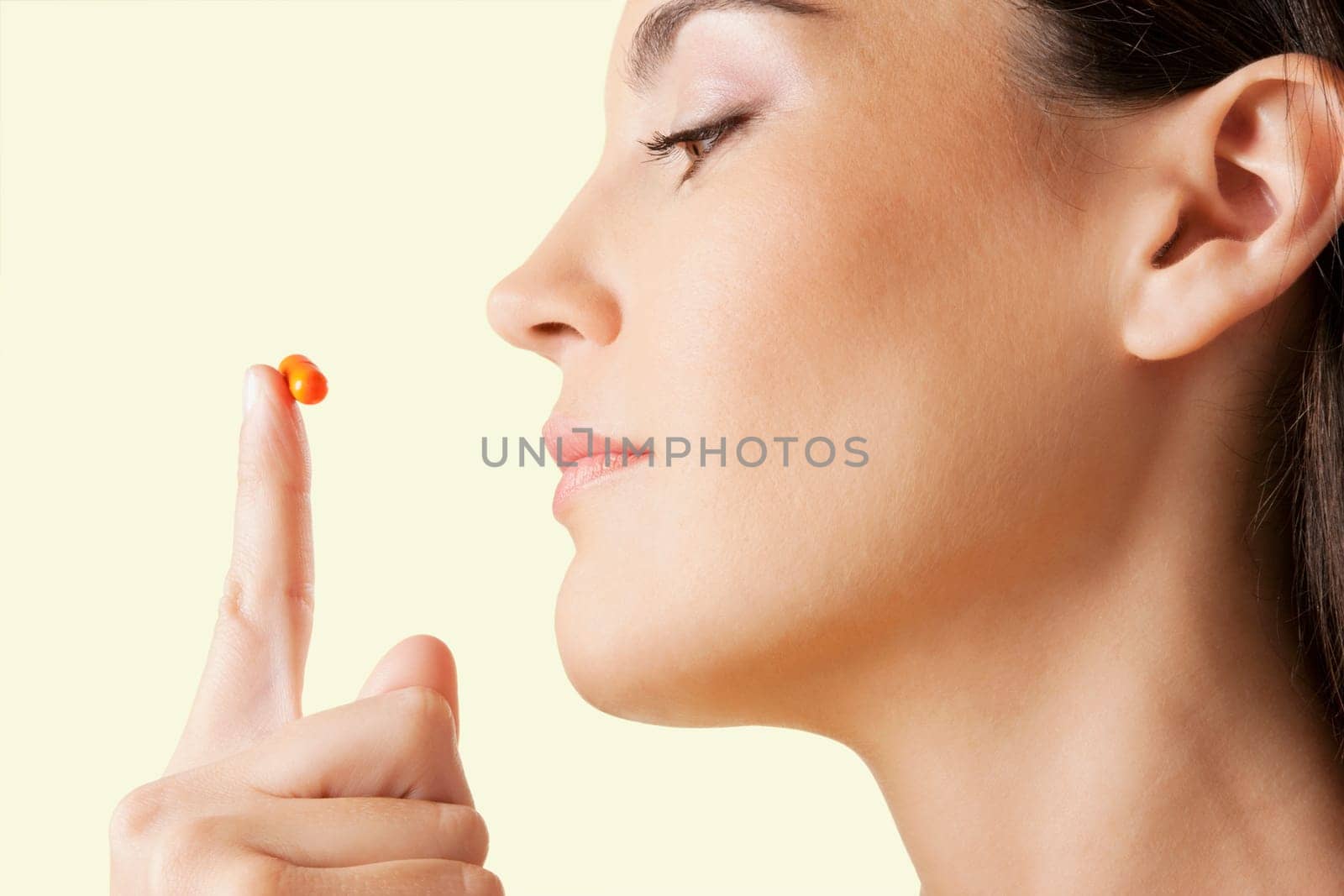 Close_up of a woman looking at a capsule