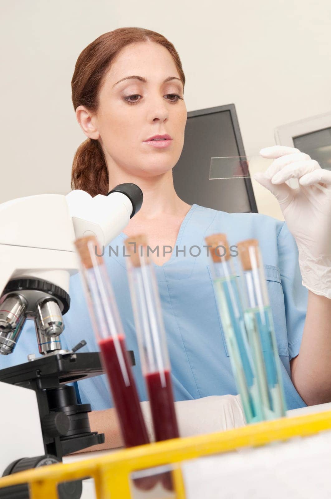 Female lab technician analyzing a sample in a laboratory