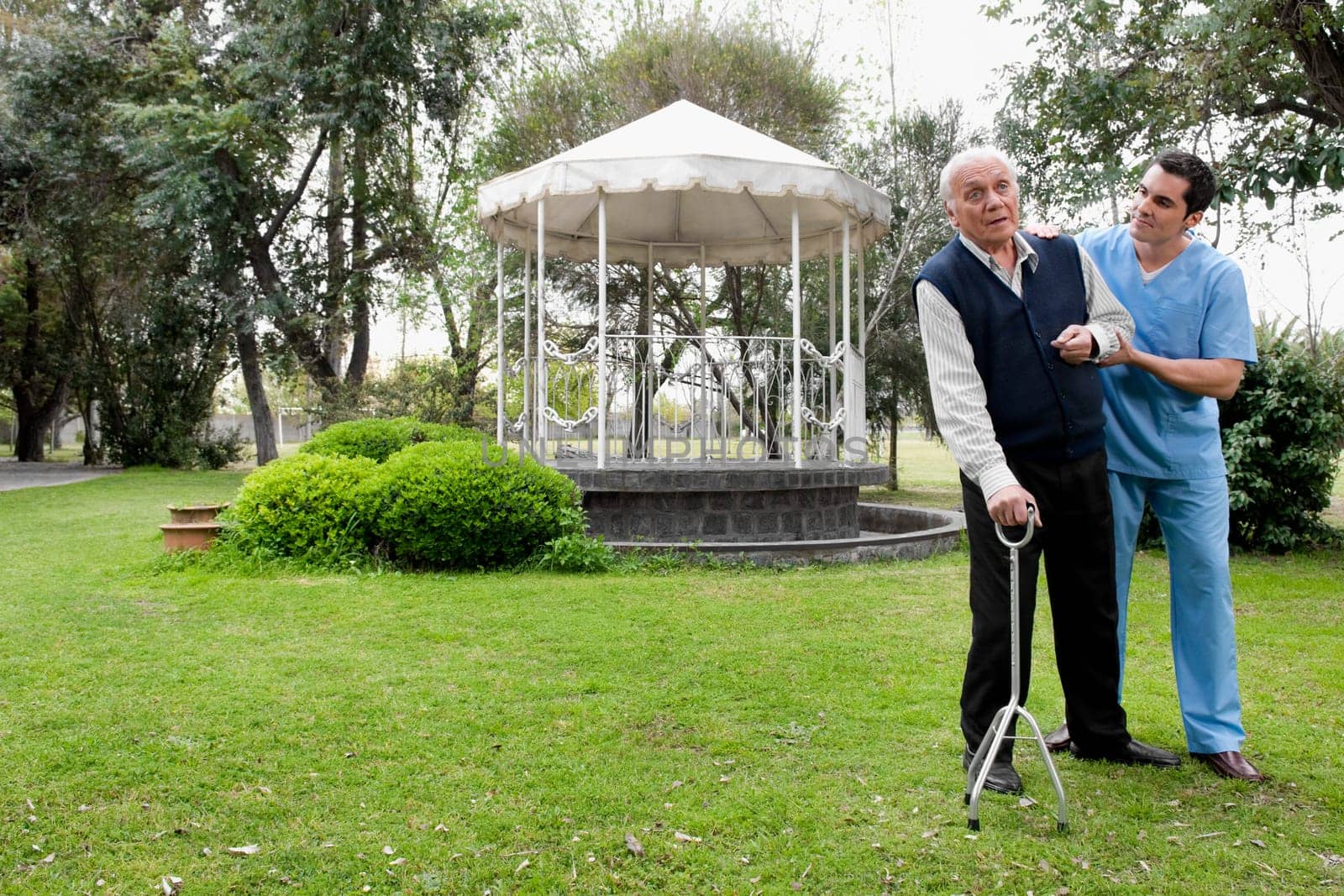 Healthcare worker assisting a patient in walking