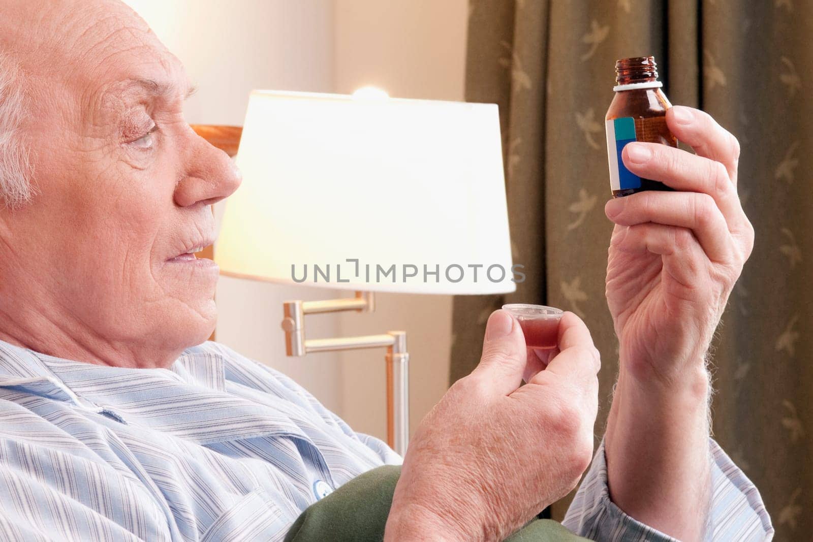Close_up of a man taking medicine