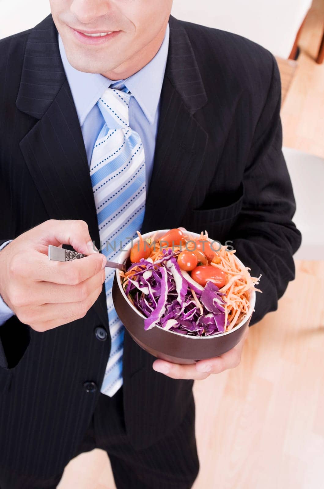 Businessman eating salad in a restaurant