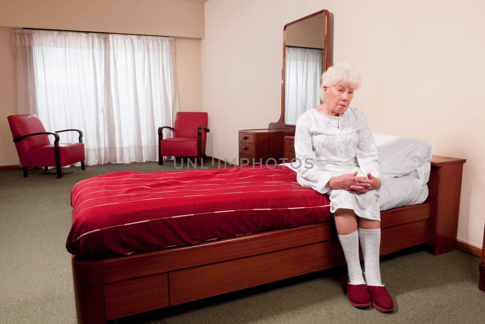Woman sitting on the bed in a rehabilitation center