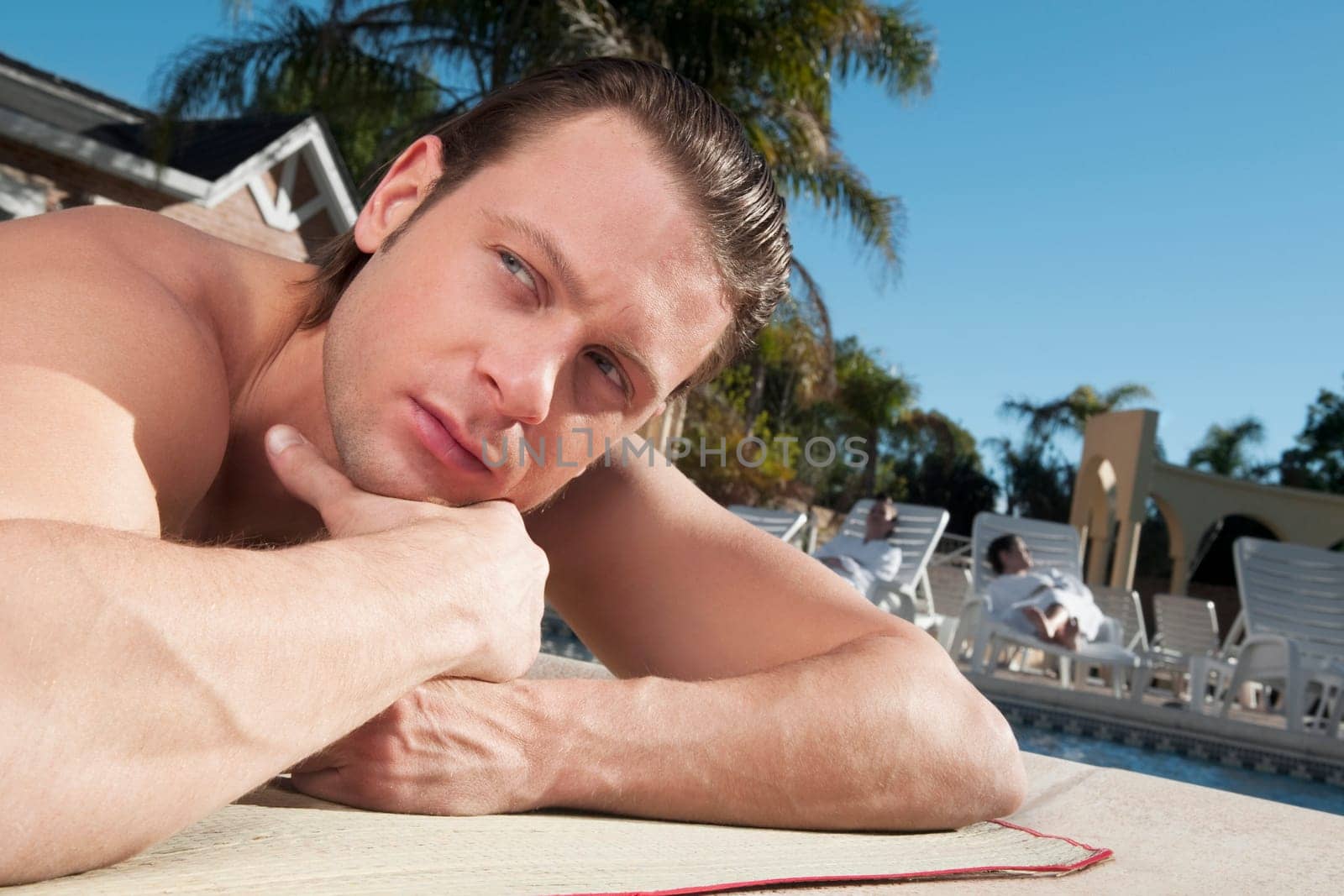 Man resting at the poolside