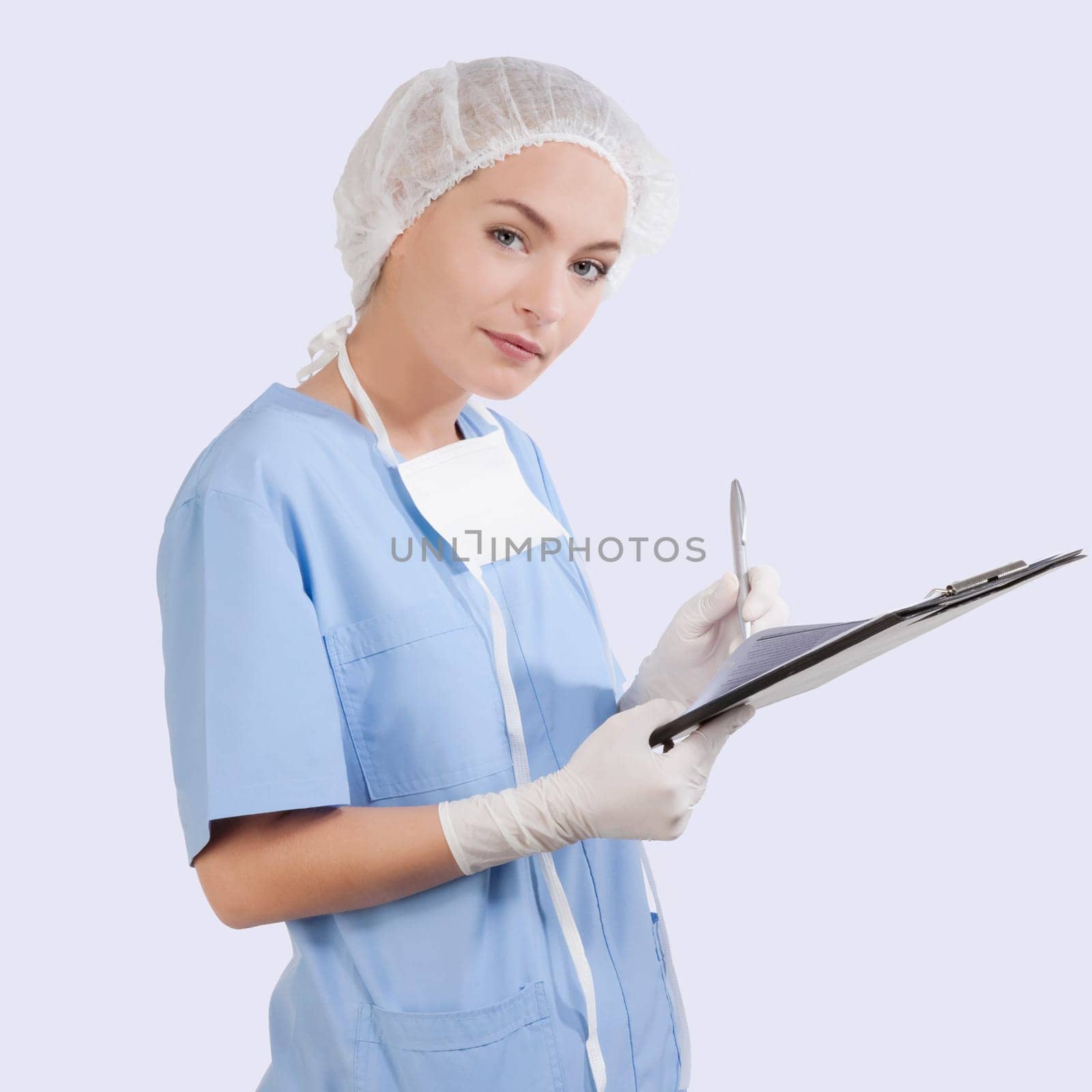 Female surgeon writing on a clipboard