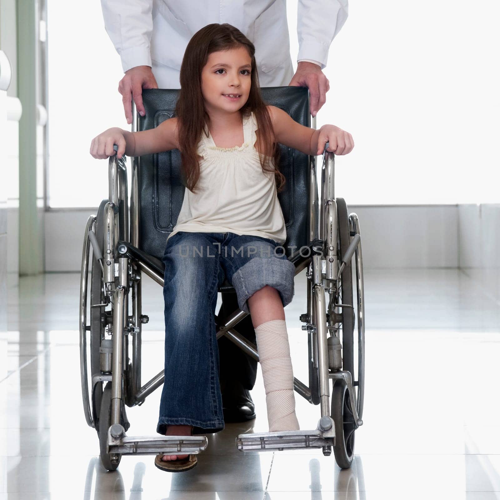 Doctor pushing a patient in a wheelchair