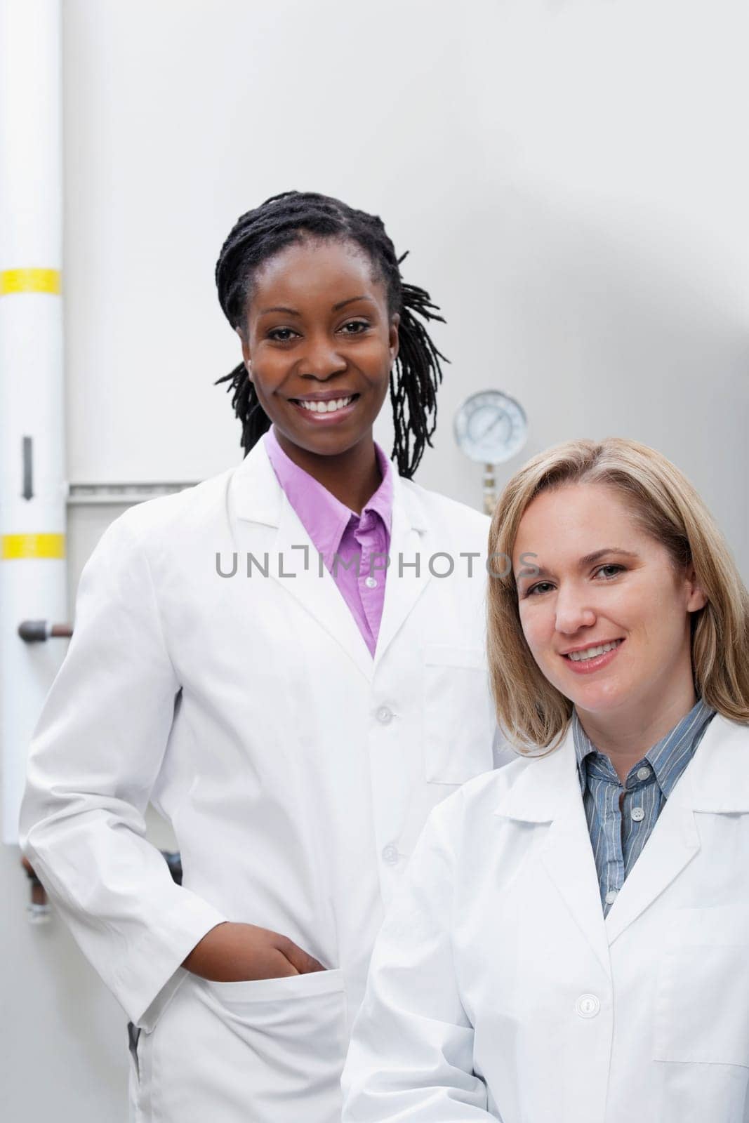 Portrait of two female doctors smiling in a laboratory