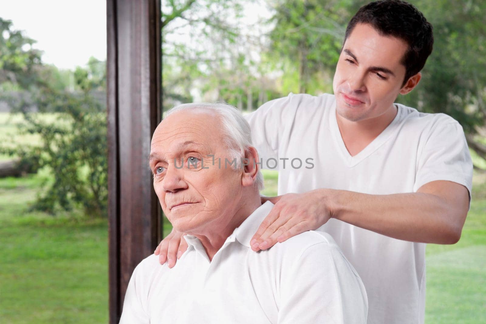 Massage therapist massaging a manŽs neck