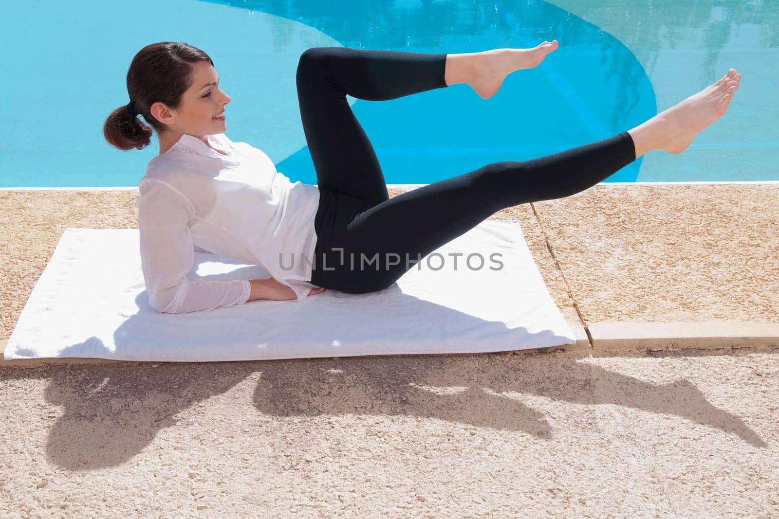 Woman exercising at the poolside
