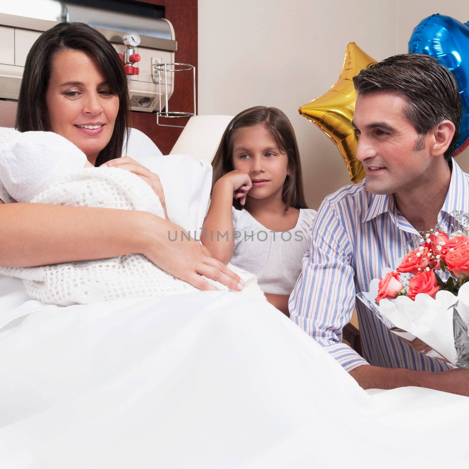 Couple with their newborn baby in a hospital