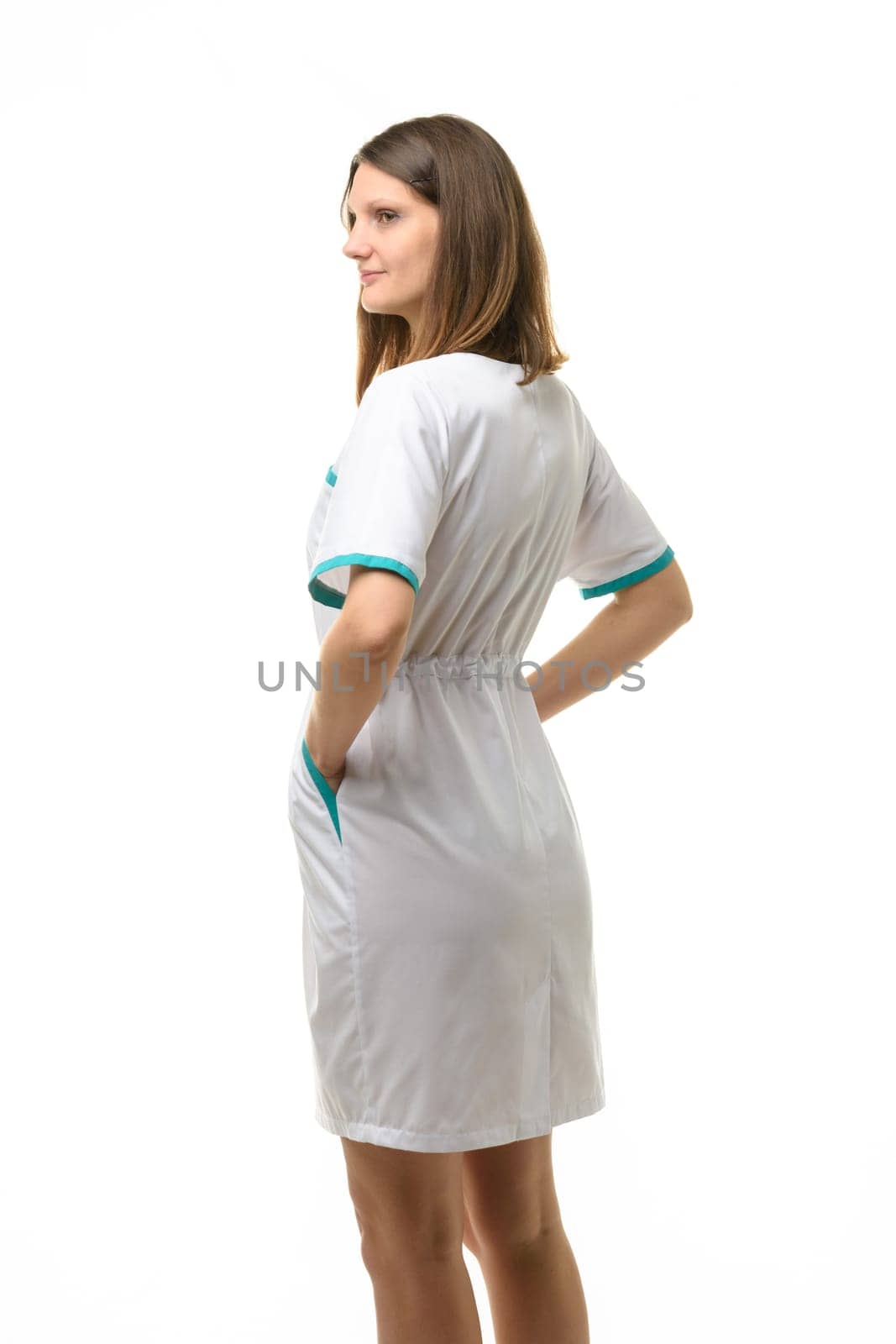 Side view of girl in white medical coat, isolated on white background