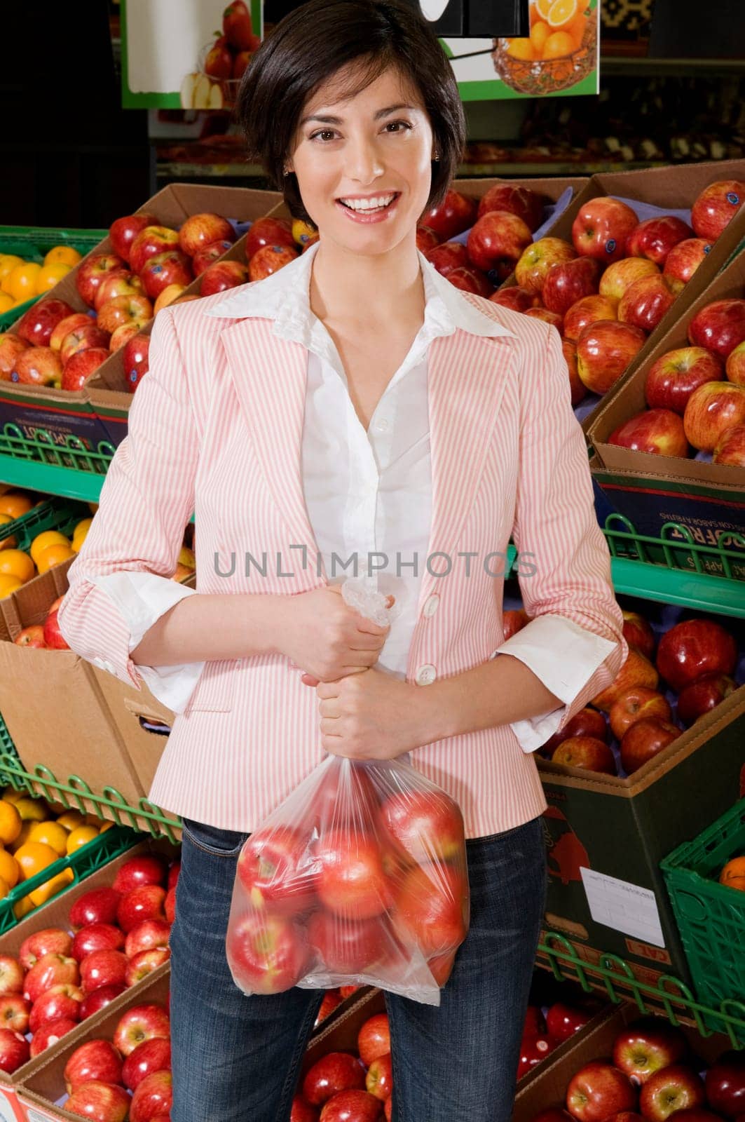 Woman buying apples in a supermarket