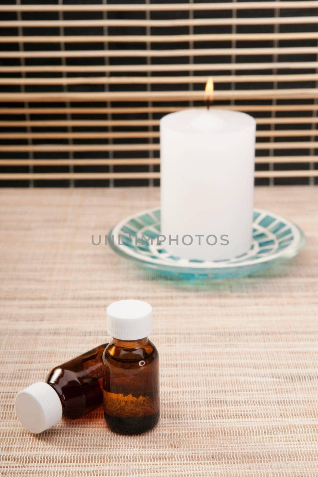 Candle with aromatherapy oil bottles