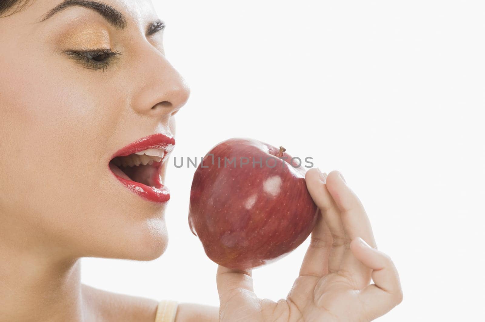 Close_up of a woman eating a red apple