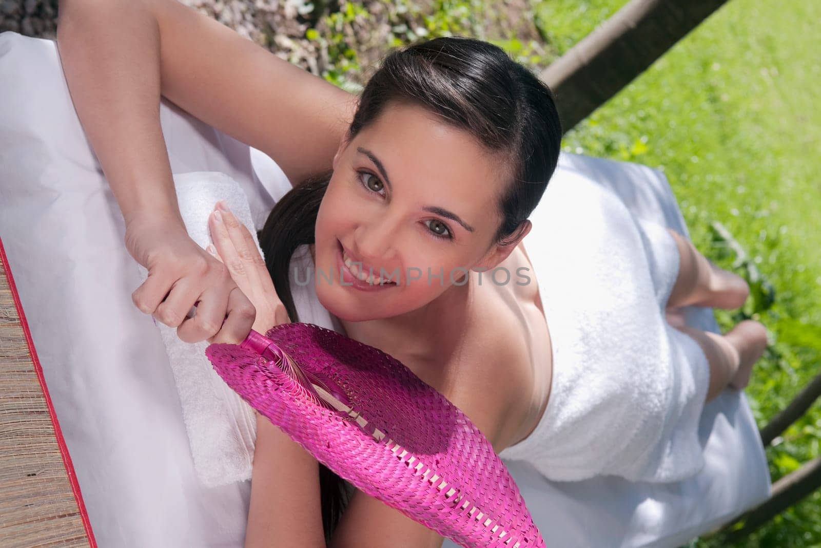 Portrait of a woman lying on a massage table and smiling