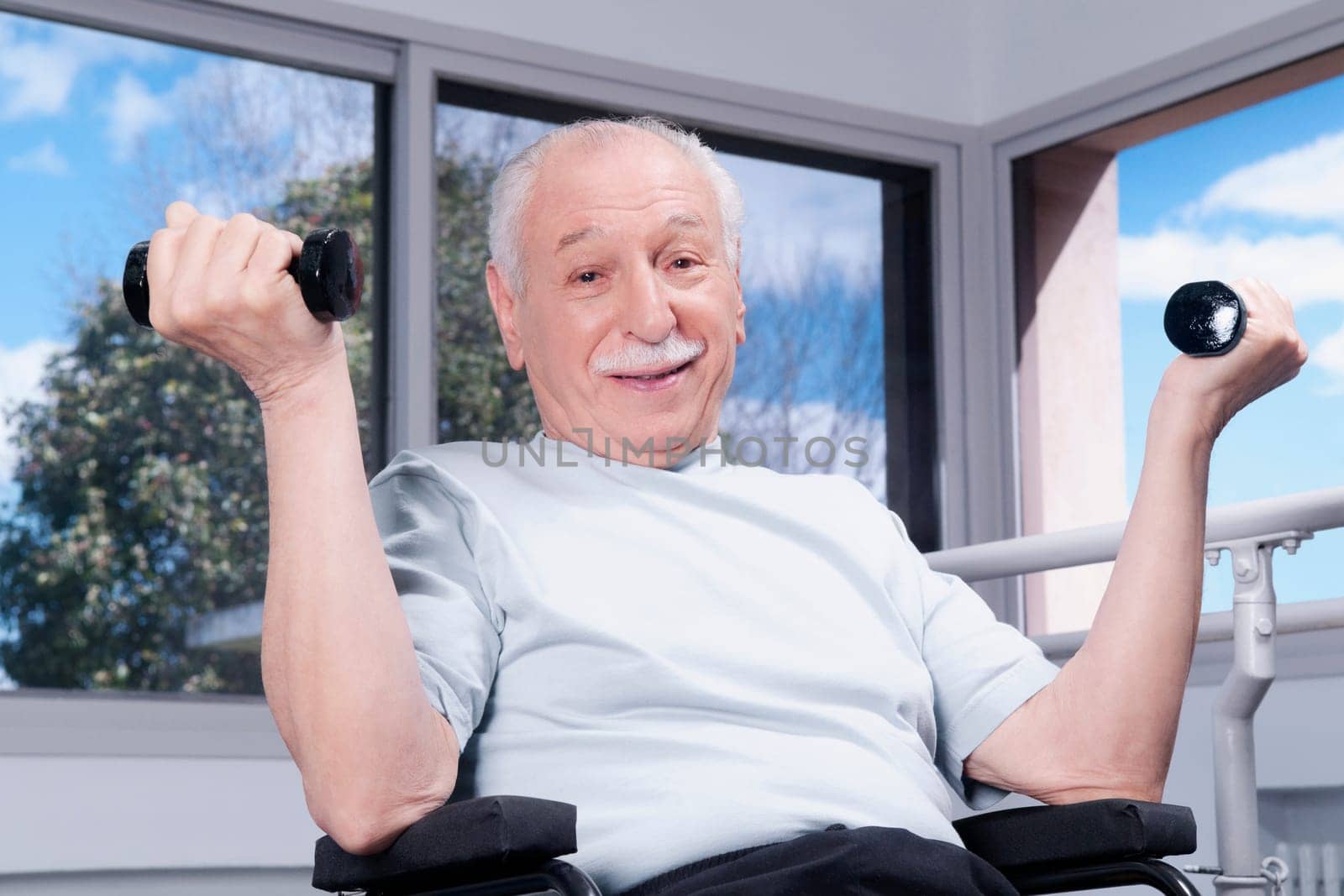 Disabled man exercising with dumbbells