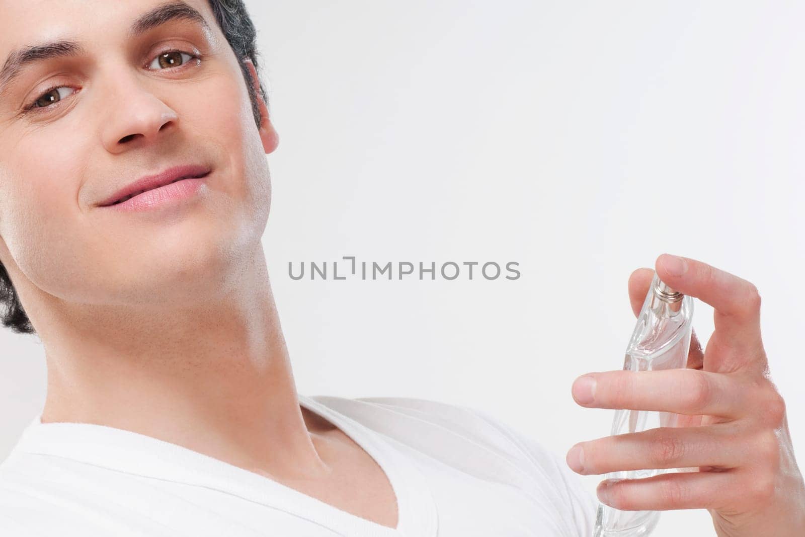 Man holding a perfume bottle