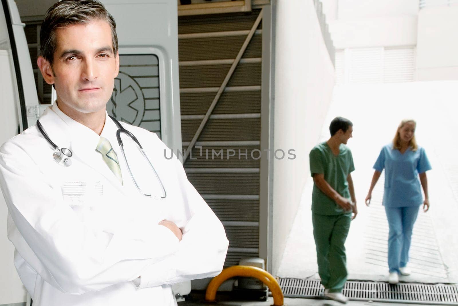 Portrait of a doctor with nurses in the background
