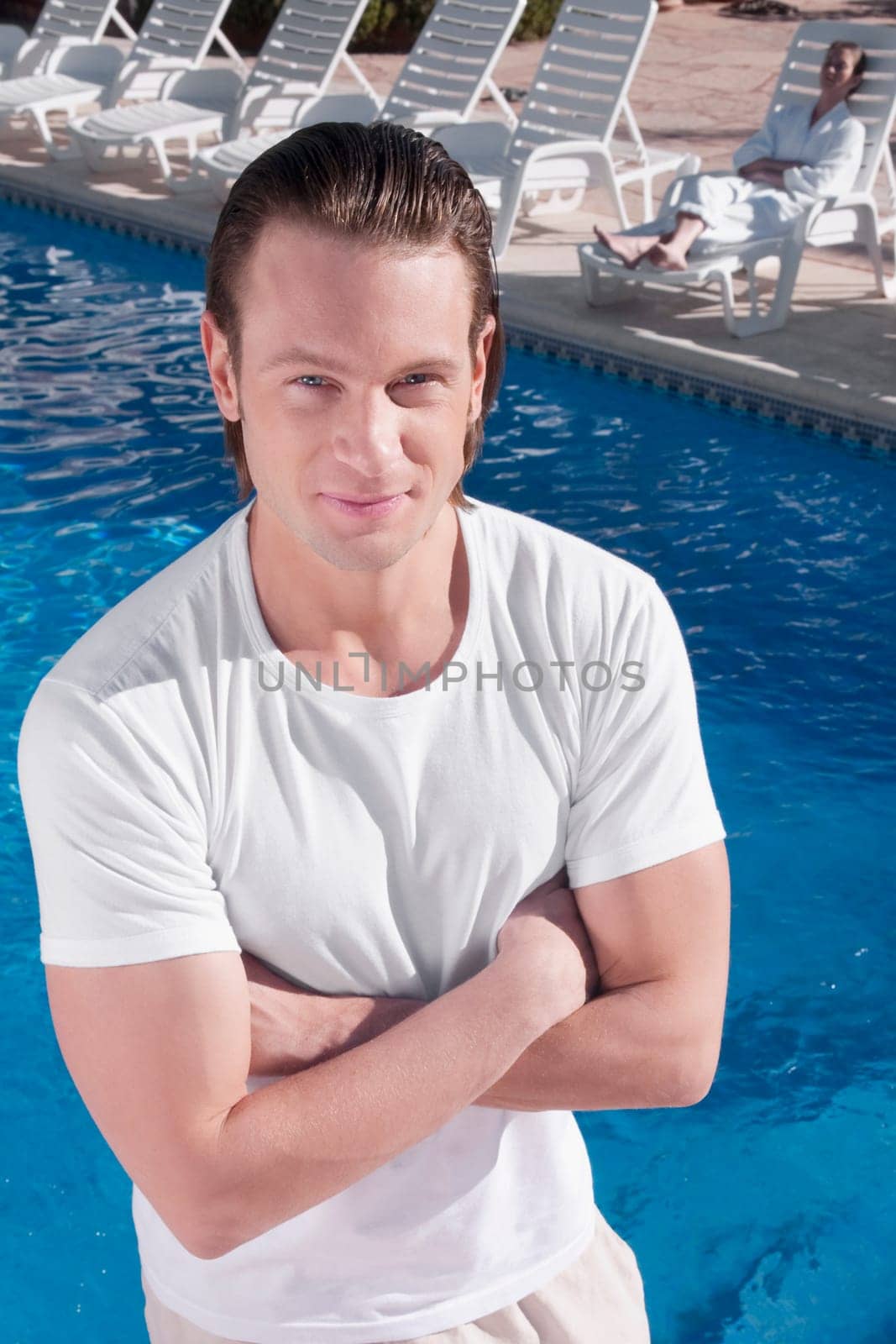 Portrait of a man standing near a swimming pool