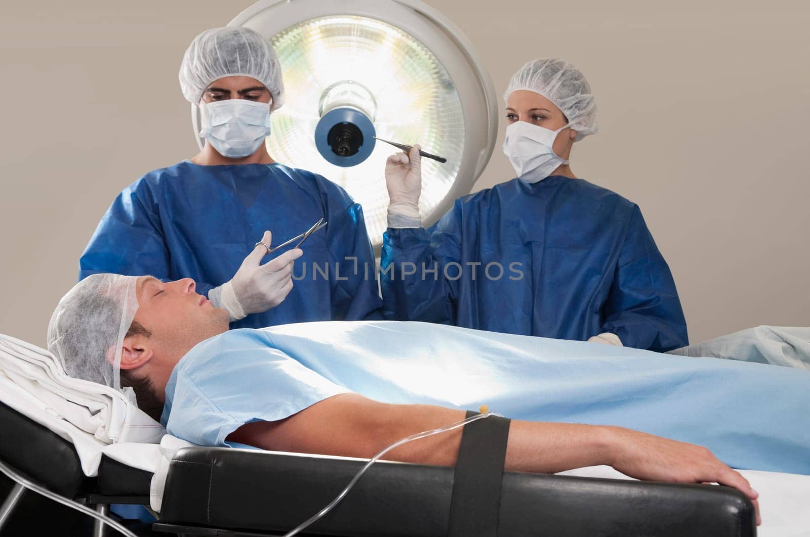 Two surgeons operating a patient in an operating room