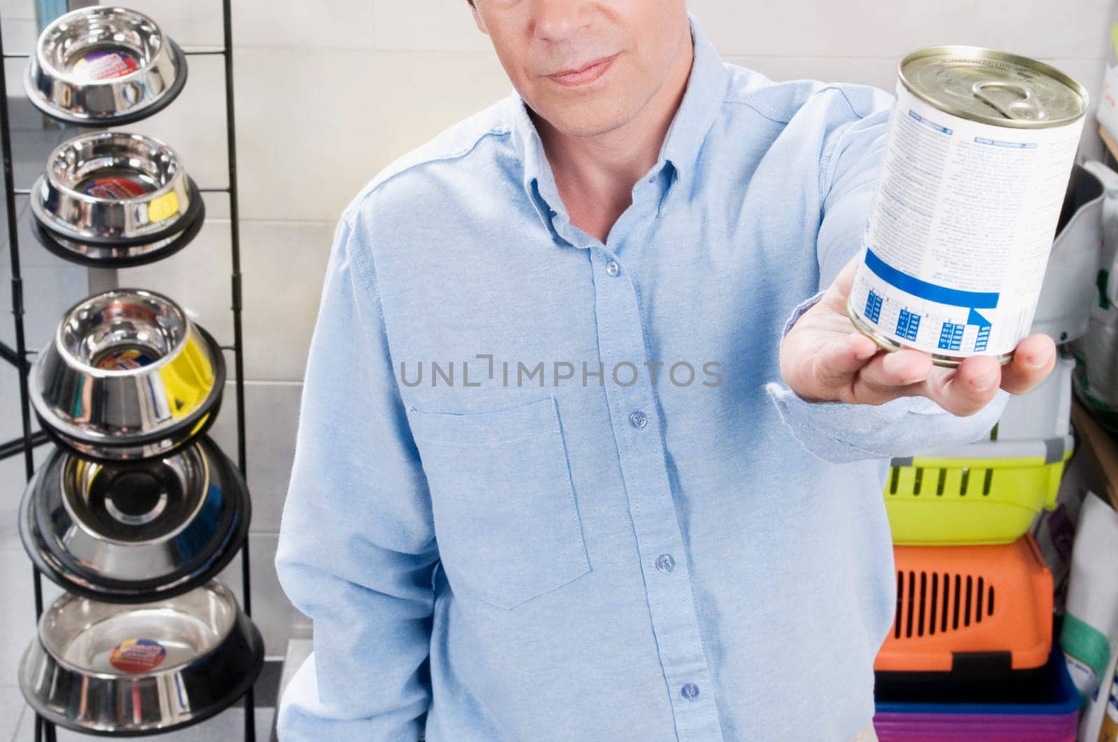 Man buying dog food in a supermarket