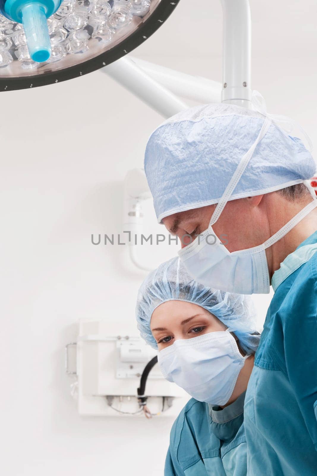 Surgeons performing a surgery in an operating room