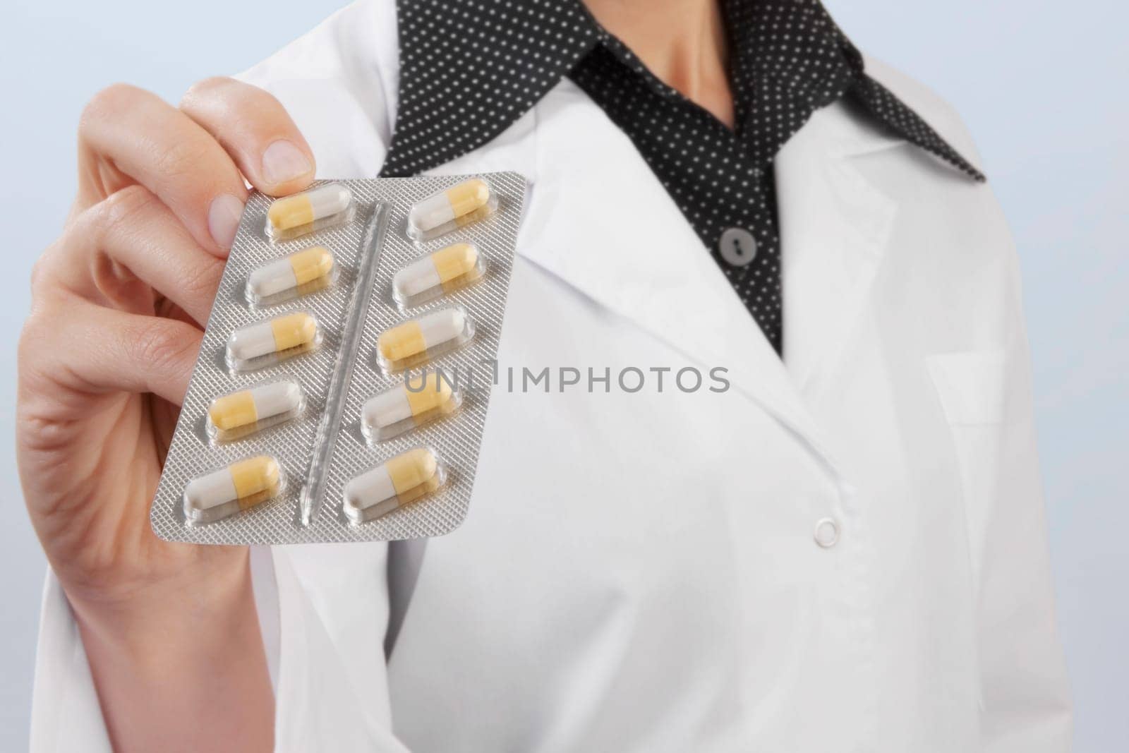 Female doctor showing a blister pack of capsules