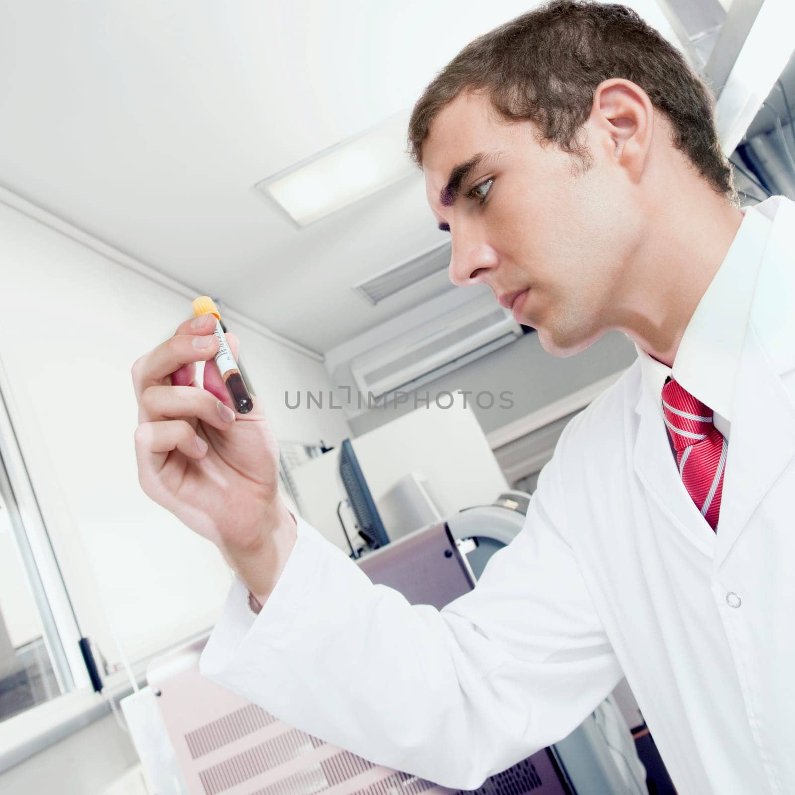 Lab technician testing a blood sample in a test tube